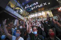 Pro-democracy demonstrators flash a three-finger salute of defiance during a protest rally in the Silom business district of Bangkok, Thailand, Thursday, Oct. 29, 2020. The protesters continue to gather Thursday with their three main demands of Prime Minister Prayuth Chan-ocha's resignation, changes to a constitution that was drafted under military rule and reforms to the constitutional monarchy. (AP Photo/Sakchai Lalit)