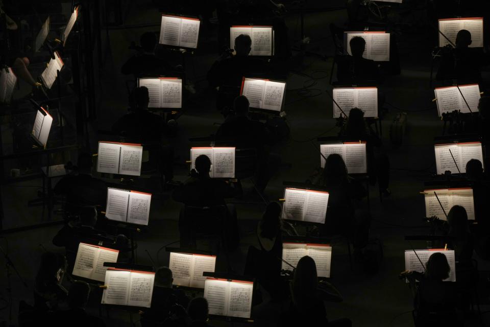 Musicians perform during 'I Pagliacci' (The Clowns) lyric opera, at the Arena di Verona theatre, in Verona, Italy, Friday, June 25, 2021. The Verona Arena amphitheater returns to staging full operas for the first time since the pandemic struck but with one big difference. Gone are the monumental sets that project the scene to even nosebleed seats in the Roman-era amphitheater, replaced by huge LED screens with dynamic, 3D sets that are bringing new technological experiences to the opera world. (AP Photo/Luca Bruno)