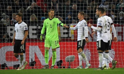Germany's goalkeeper Manuel Neuer fist bumps Toni Kroos after saving a penalty against Belarus on Saturday