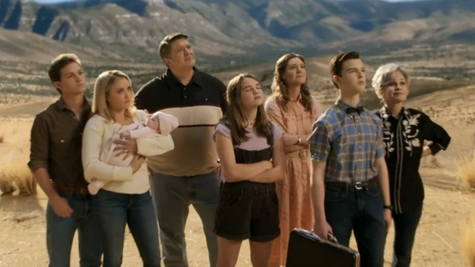 Georgie, Mandy, baby Constance, George Sr, Missy, Mary, Sheldon, and Connie standing together in a field