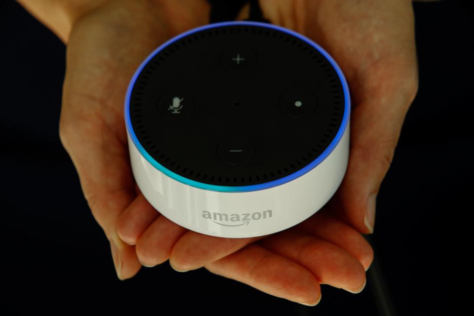 A person holds an Echo Dot, the smaller version of the Amazon Echo. Bloomberg via Getty Images.