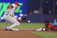 Philadelphia Phillies second base Bryson Stott, left, prepares to tag out Miami Marlins' Jazz Chisholm Jr. after Chisholm attempted to steal second base during the first inning of a baseball game, Saturday, May 11, 2024, in Miami. (AP Photo/Wilfredo Lee)