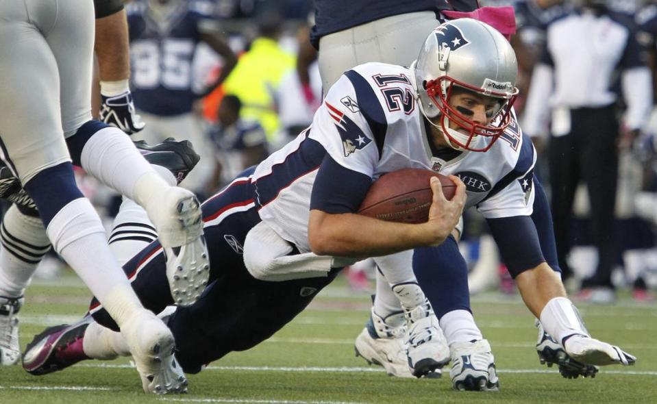 New England Patriots quarterback Tom Brady (12) dives for yardage against the Cowboys at Gillette Stadium on Oct. 16, 2011.