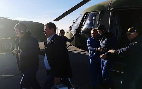 Rescuers help the two crew members out of a helicopter in Kazakhstan - Credit: Russian Central Military District/TASS via Getty Images