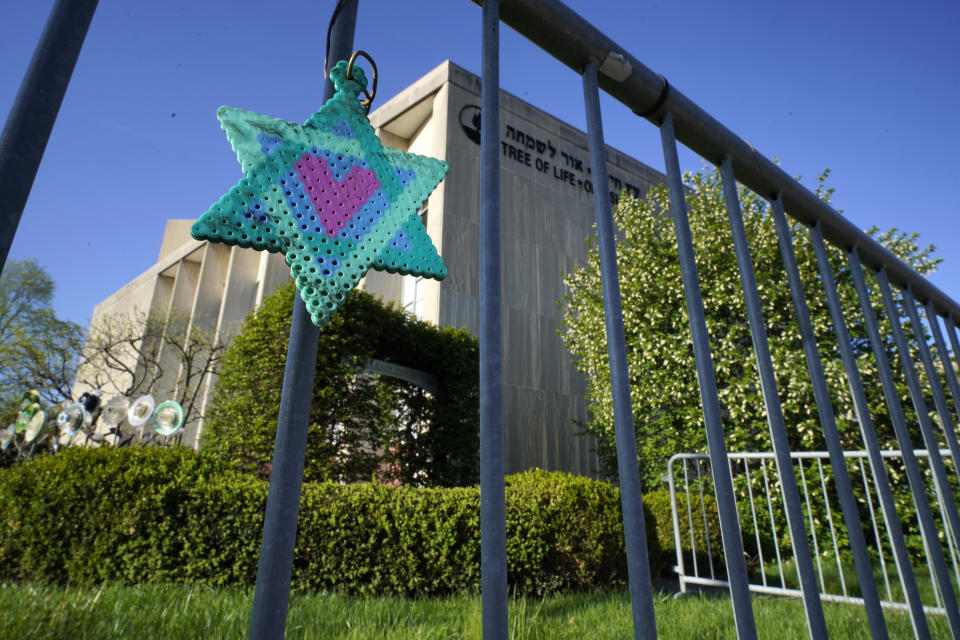 FILE - A Star of David hangs from a fence outside the dormant landmark Tree of Life synagogue in Pittsburgh's Squirrel Hill neighborhood, Apr. 19, 2023. Robert Bowers. Bowers, the gunman who massacred 11 worshippers at a Pittsburgh synagogue in 2018, has a “very serious mental health history" from childhood and a “markedly abnormal” brain, a defense expert testified Wednesday, June 28, 2023, in the penalty phase of the Bowers' trial. (AP Photo/Gene J. Puskar, File)
