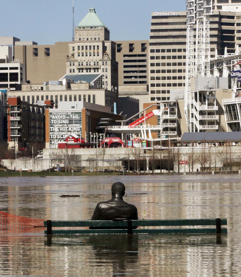 <p>The Stature of James Bradley and trash can are almost covered by the waters of the Ohio River in Cincinnati as the river floods the anks of Covington, Ky., and Cincinnati, Ohio on Monday, Feb. 26, 2018. (Photo: Ernest Coleman via ZUMA Wire) </p>