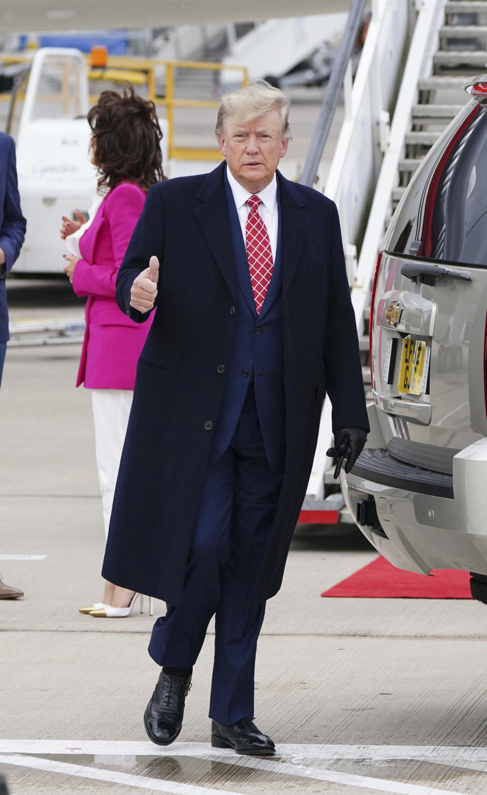 Former US president Donald Trump gestures as he arrives at Aberdeen International Airport ahead of his visit to the Trump International Golf Links Aberdeen, in Dyce, Aberdeen, Scotland, Monday May 1, 2023. (Jane Barlow/PA via AP)