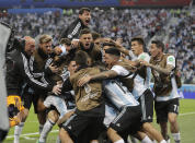 <p>Unbridled joy: Argentina players celebrates his Marcos Rojo’s late winner </p>