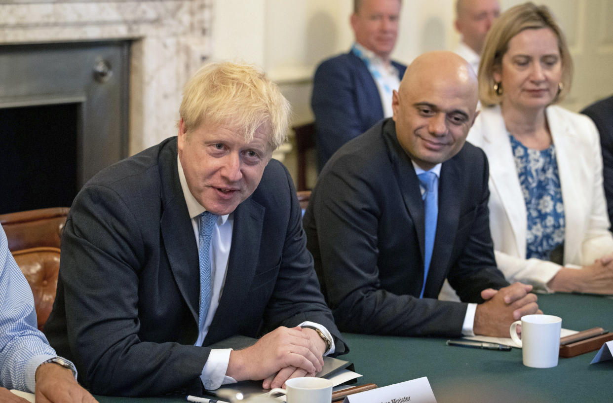 Britain's newly appointed Prime Minister Boris Johnson, left, holds his first Cabinet meeting, with Chancellor of the Exchequer Sajid Javid and Secretary for Work and Pensions Amber Rudd, right, at Downing Street in London, Thursday July 25, 2019. Johnson held his first Cabinet meeting Thursday as prime minister, pledging to break the Brexit impasse that brought down predecessor Theresa May.(Aaron Chown/Pool via AP)