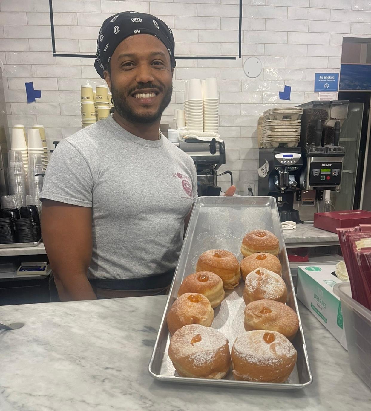 Willy Rincon displays apricot-filled powdered donuts at Dough in Rockefeller Center.