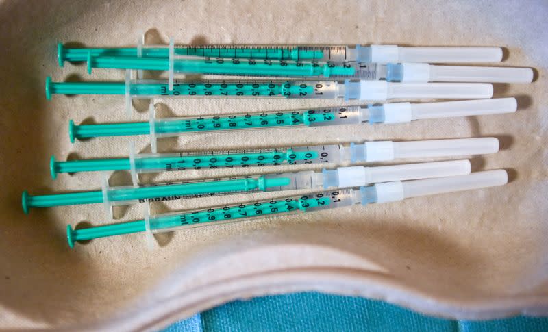 FILE PHOTO: Pharmacist Susanne Wohlgemuth prepares Pfizer/BioNTech COVID-19 vaccinations at the Haus an der Linde nursing home in Lichtentanne, Saxony, Germany