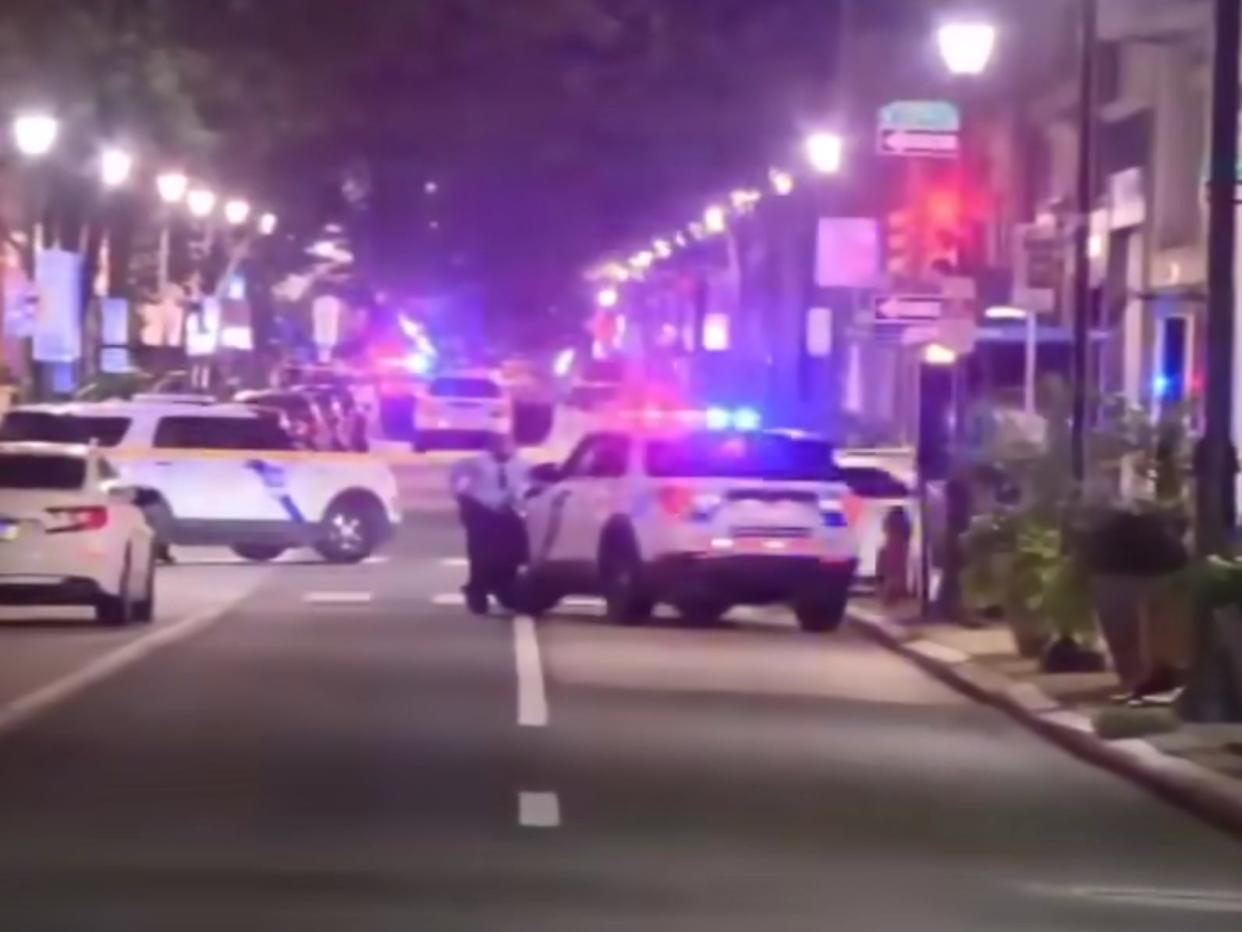 A blurry screenshot of police cars on a street at night.