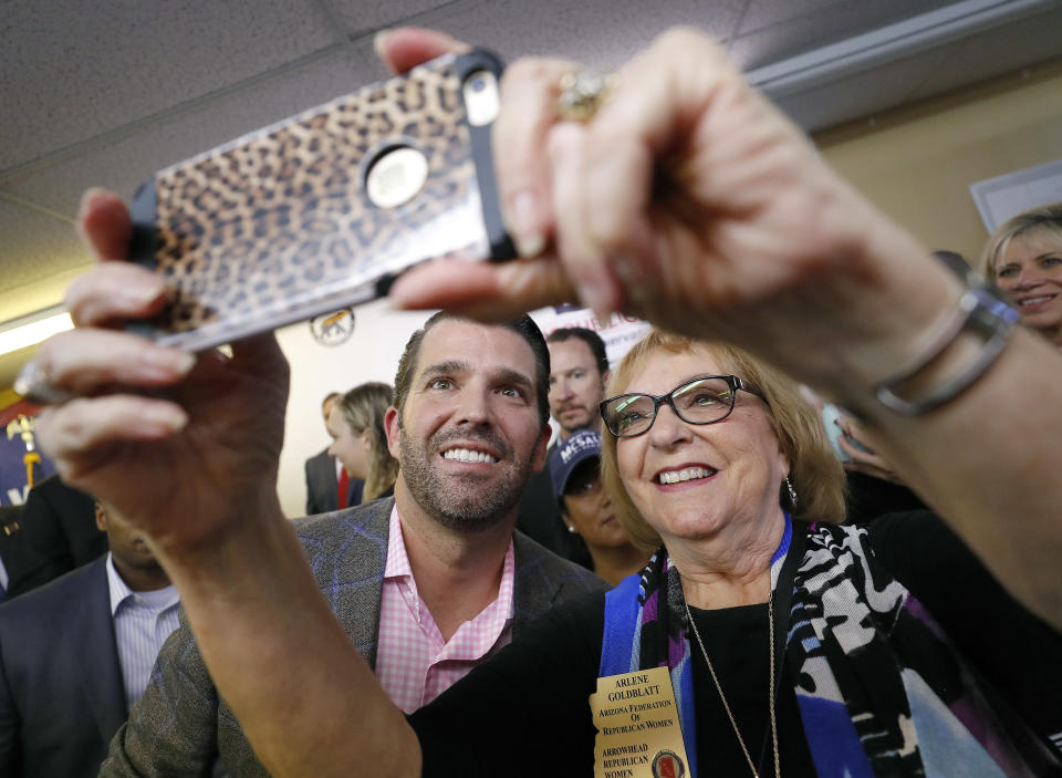 Donald Trump Jr. takes a selfie with Arlene Goldblatt after a campaign rally for U.S. Senate candidate Martha McSally, Thursday, Nov. 1, 2018, in Sun City, Ariz. (AP Photo/Matt York)