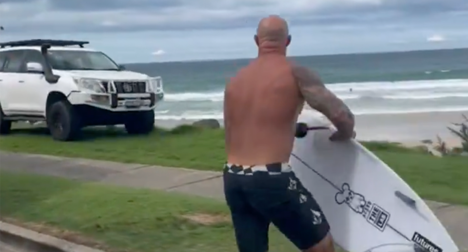 A stunned surfer is seen watching on as a man made off with another man's Toyota Prado at Duranbah Beach. 