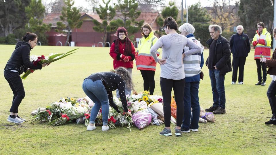 Woman lay flowers and play their respects at Princes Park, Carlton North, where <span>Eurydice Dixon’s body was found. Source: AAP</span>