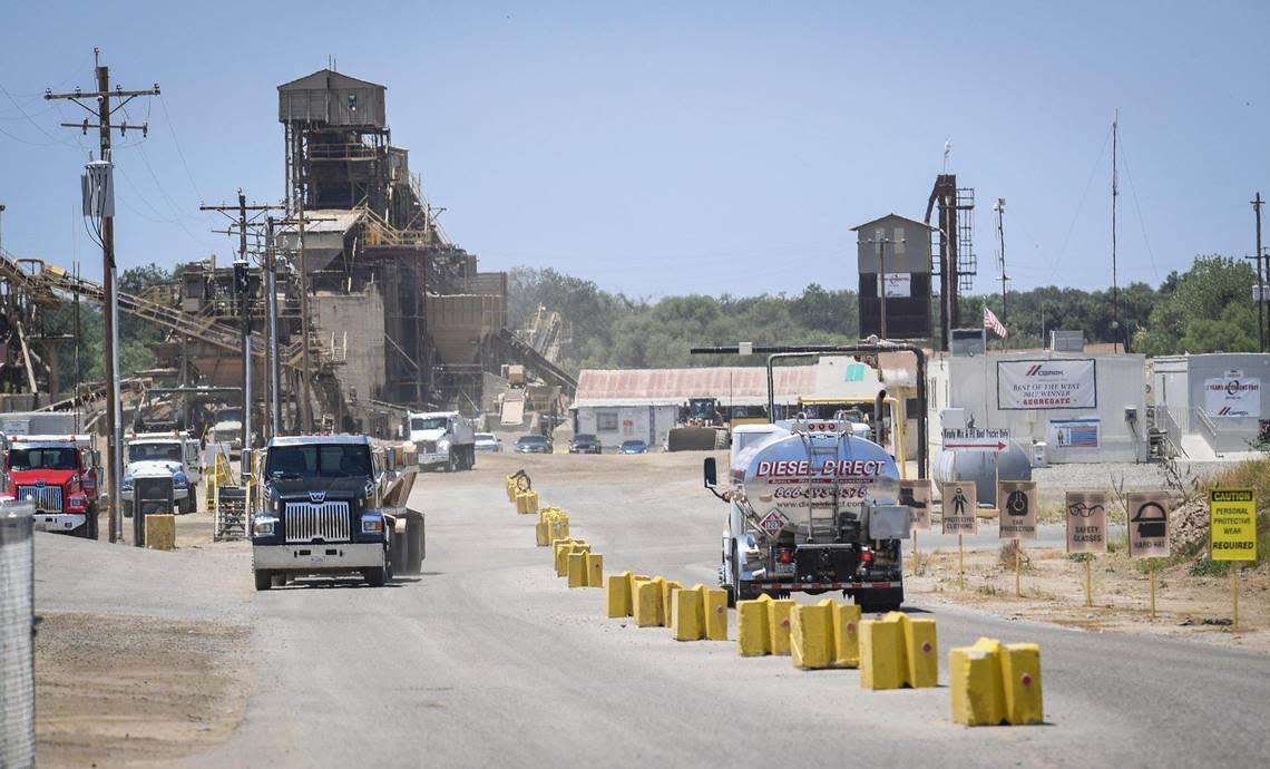 Trucks come and go at the entrance to the CEMEX Rockfield aggregate plant site in Friant on Wednesday, June 17, 2020. The company applied to Fresno County to continue mining the quarry for 100 years, and use blasting and drilling to mine a 600-ft deep pit.
