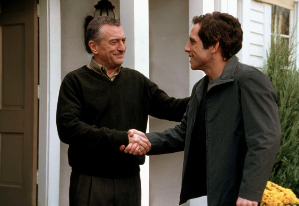 Robert De Niro and Ben Stiller shaking hands.