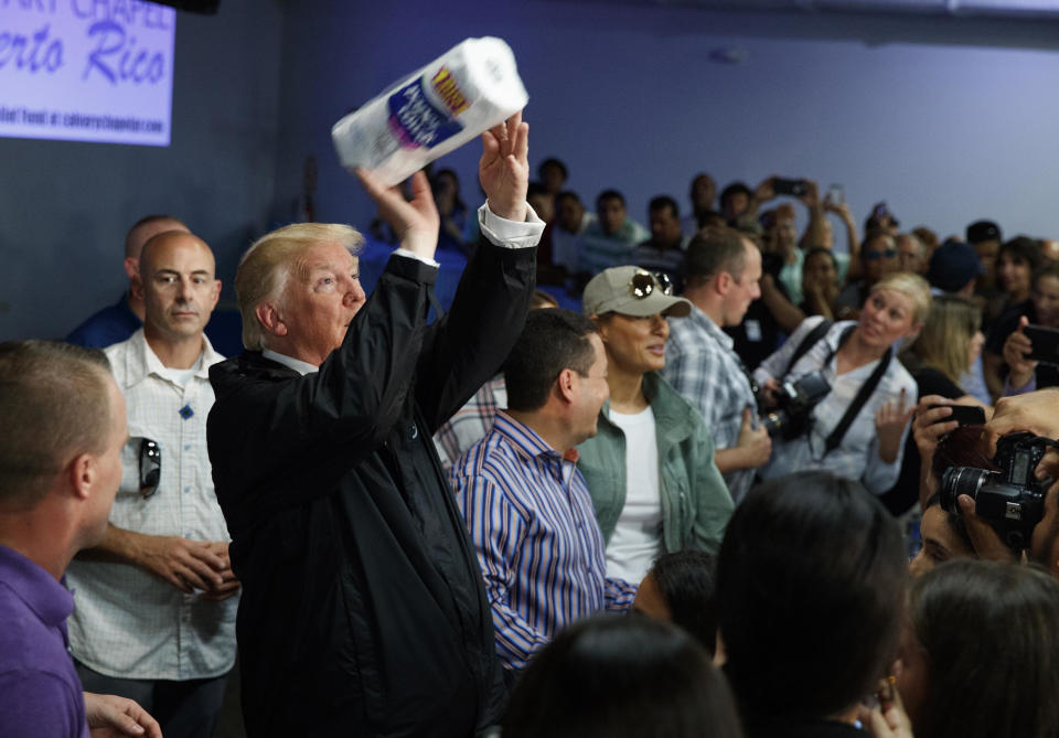 FILE - In this Oct. 3, 2017 file photo, President Donald Trump tosses paper towels into a crowd at Calvary Chapel in Guaynabo, Puerto Rico. (AP Photo/Evan Vucci, File)