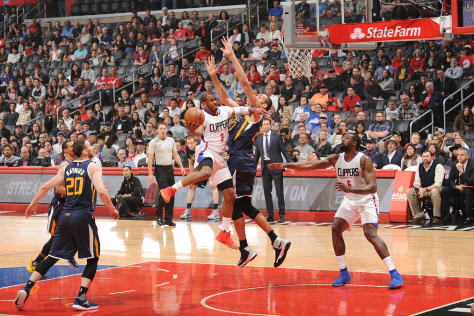 Chris Paul knifes through the Jazz defense and meets Rudy Gobert at the rim. (Andrew D. Bernstein/NBAE/Getty Images)