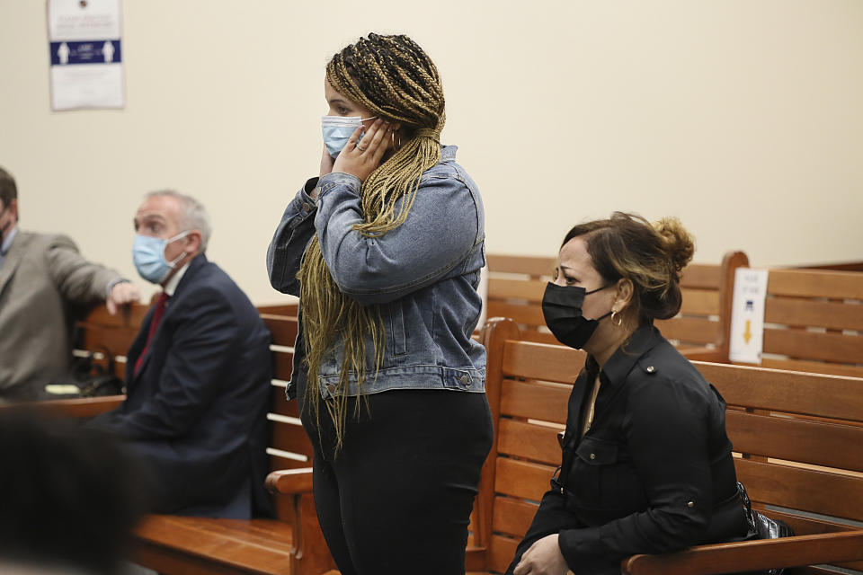 Family members react as some of the 11 people charged in connection with an armed standoff along a Massachusetts highway last weekend, are arraigned at Malden District Court, Tuesday, July 6, 2021, in Medford, Mass. (Suzanne Kreiter/The Boston Globe via AP, Pool)