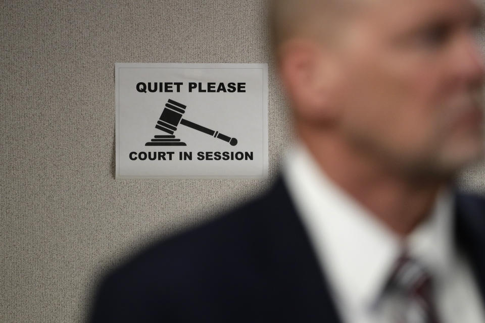 A sign is seen on the wall of a courtroom in a new ten facility during a walkthrough of the Migration Protection Protocols Immigration Hearing Facility, Tuesday, Sept. 17, 2019, in Laredo, Texas. (AP Photo/Eric Gay)