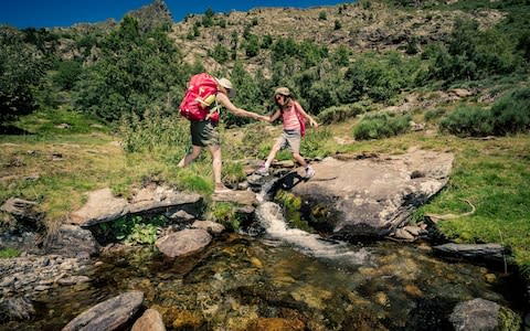 A mother and daughter trek in the mountains - Credit: aluxum/E+