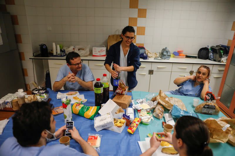 Nurse Ines Lopes with her fellow nurses eat at the night shift at Sao Jose Hospital in Lisbon