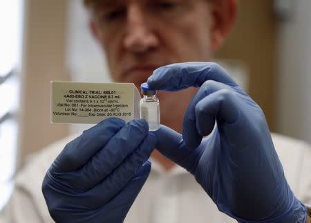 Professor Adrian Hill, Director of the Jenner Institute, and Chief Investigator of the trials, holds a phial containing the Ebola vaccine at the Oxford Vaccine Group Centre for Clinical Vaccinology and Tropical Medicine (CCVTM) in Oxford, southern England September 17, 2014. REUTERS/Steve Parsons/Pool