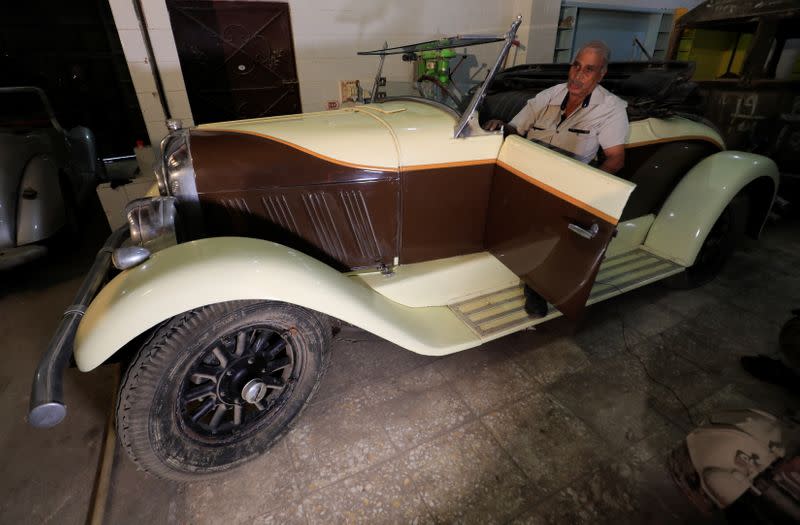 Sayed Sima, a 70-years-old Egyptian collector of vintage cars, speaks during an interview with Reuters seated on a 120-year-old American "1900 Auburn" automobile in his store in the Giza suburb of Abu Rawash