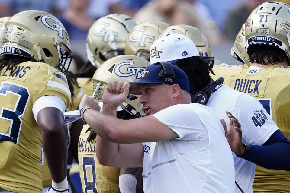 Georgia Tech head coach Geoff Collins speaks to defensive lineman Noah Collins (43) during the first half of an NCAA college football game, Saturday, Sept. 17, 2022, in Atlanta. (AP Photo/John Bazemore)