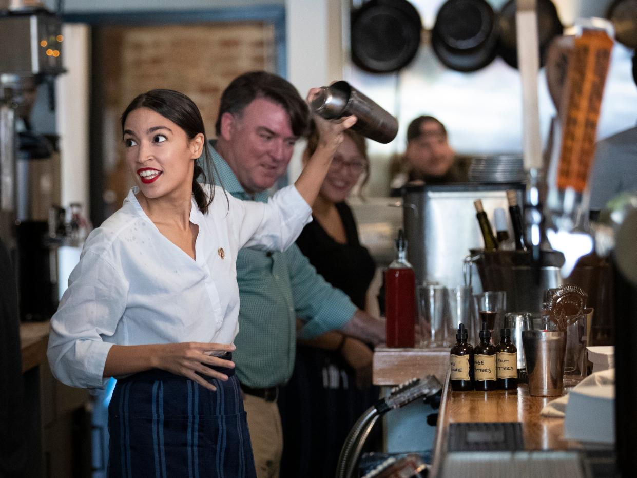 <p>U.S. Rep. Alexandria Ocasio-Cortez (D-NY) shakes a margarita behind the bar at the Queensboro Restaurant, May 31, 2019 in the Queens borough of New York City</p> (Photo by Drew Angerer/Getty Images)