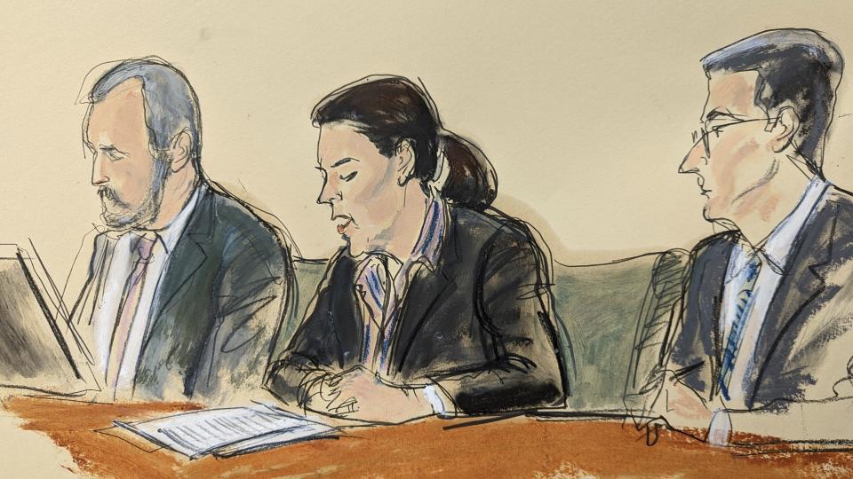 In this courtroom sketch, Magali Anderson, Chief Sustainability and Innovation Officer of Holcim, center, reads a statement of guilt in open court flanked by her attorneys, David Sarratt, left, and Douglas Zolkind in Brooklyn Federal Court, Tuesday, Oct. 18, 2022, in New York. French cement company Lafarge pleaded guilty Tuesday to paying millions of dollars to the Islamic State group in exchange for permission to keep open a plant in Syria, a case the Justice Department described as the first of its kind. The company also agreed to penalties totaling roughly $778 million. The wrongdoing precedes Lafarge’s merger with Holcim in 2015. (Elizabeth Williams via AP)