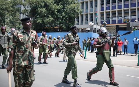 A police officer prepares to fire a tear gas to disperse supporters of Raila Odinga in downtown Nairobi, Kenya, 16 October 2017 - Credit:  EPA