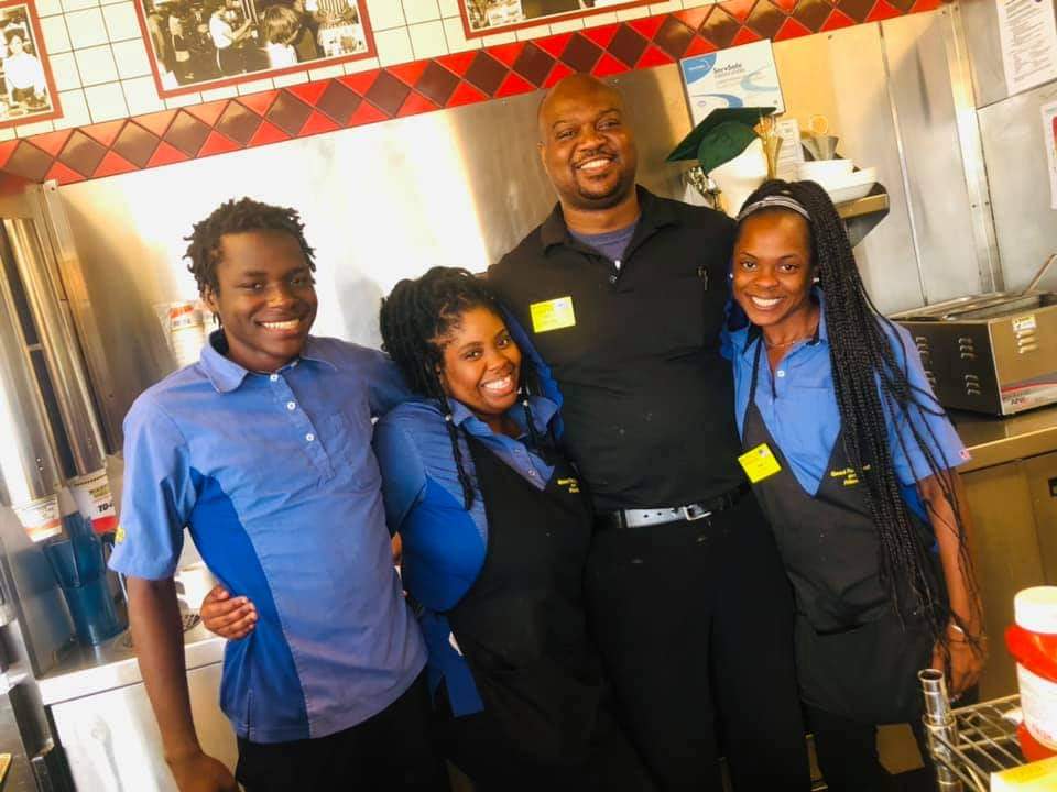 Timothy Harrison poses with his Waffle House co-workers, who helped him get to his high school graduation ceremony.