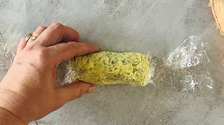 hand rolling butter in plastic