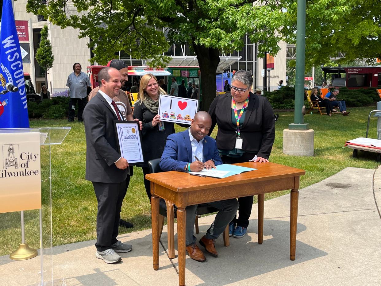 Milwaukee Mayor Cavalier Johnson, joined by Ald. Jonathan Brostoff, Ald. JoCasta Zamarripa and food truck vendors, signed new legislation regulating food trucks on June 14, 2023, in Red Arrow Park.