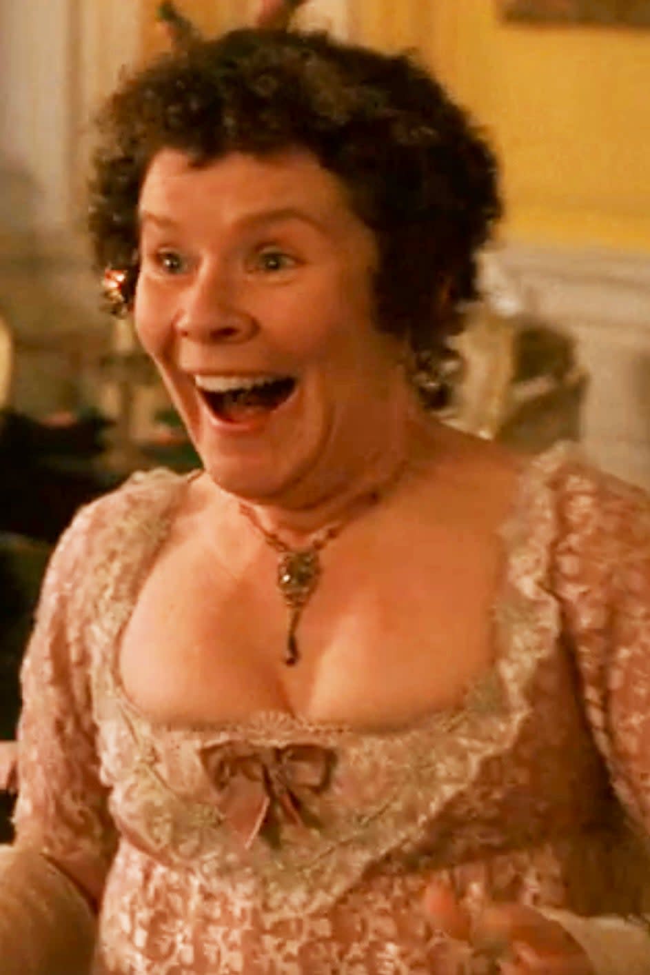 Imelda Staunton as a character in historical attire, looking excited with a joyful expression