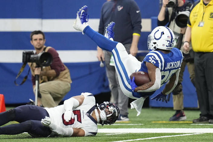 Indianapolis Colts running back Deon Jackson is upended with a tackle by Houston Texans safety Jalen Pitre (5) during the first half of an NFL football game between the Houston Texans and Indianapolis Colts, Sunday, Jan. 8, 2023, in Indianapolis. (AP Photo/Darron Cummings)