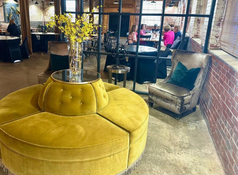 A velvet seating area for guests as they arrive at Her Majesty Kitchen in Forsyth.