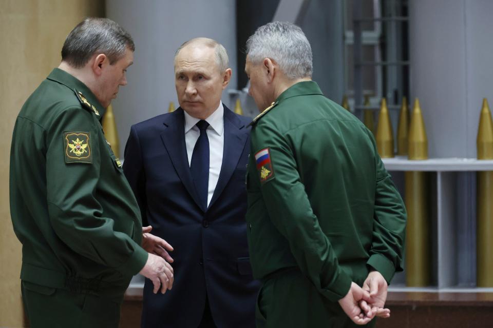 Russian President Vladimir Putin, center, talks with Gen. Valery Gerasimov, left, chief of the General Staff, and Defense Minister Sergei Shoigu after a meeting in Moscow, Russia (AP)