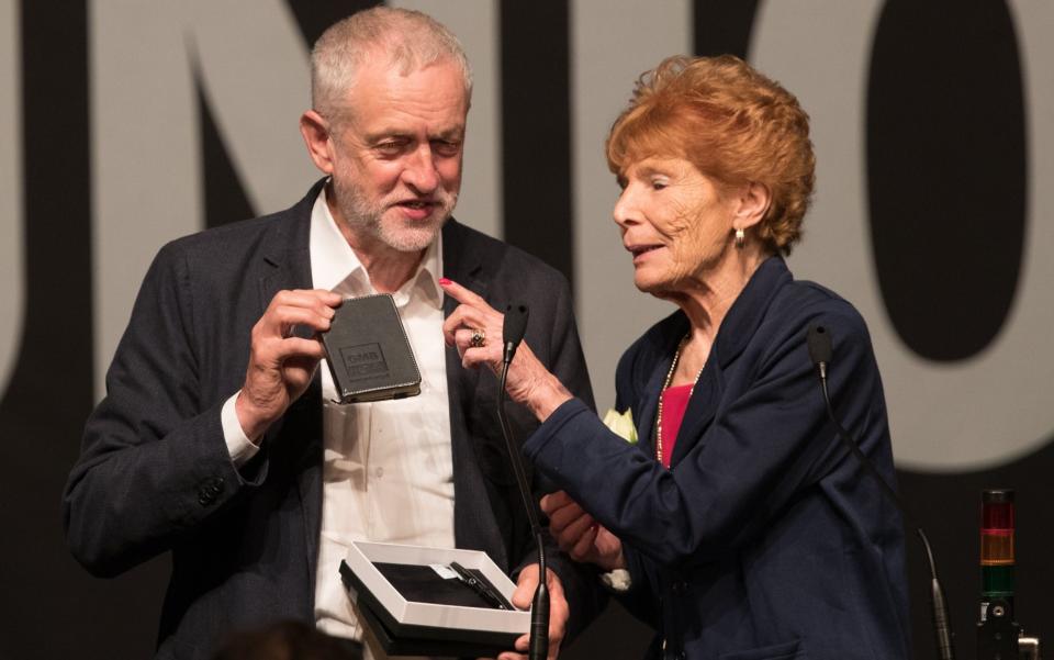 GMB president Mary Turner gives a gift to Labour Party leader Jeremy Corbyn after he spoke at the GMB Congress - Credit: Matt Cardy 