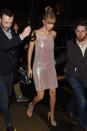 <p>The model wears a shimmery Adam Selman dress and nude Stuart Weitzman sandals. </p>