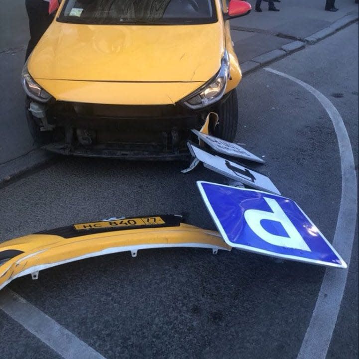 The taxi lost a bumper and toppled a parking sign during the incident - Twitter
