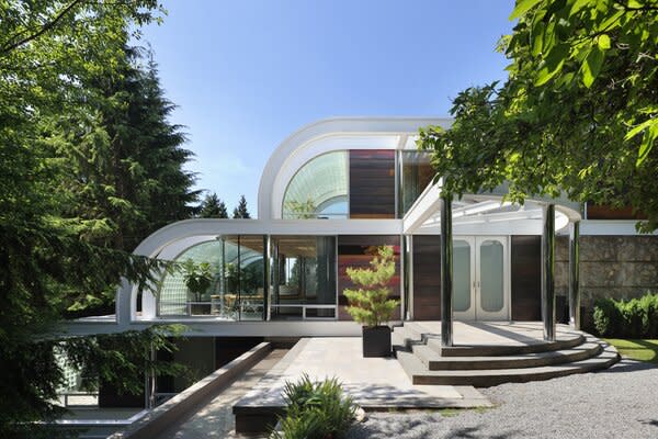 The home's unique use of glass and steel—along with its curved, multi-level structure—can be savored upon arrival. Soaring trees pepper the large property, creating a peaceful oasis.