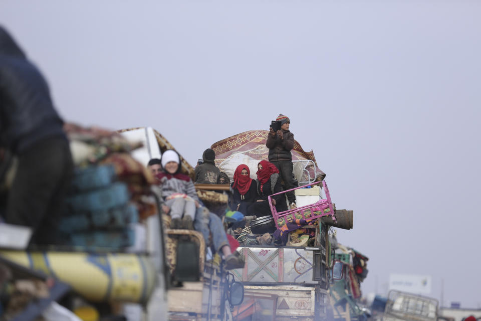 Syrian flee the advance of the government forces in the province of Idlib, Syria, towards the Turkish border, Wednesday, Jan. 29, 2020. Syrian government forces captured one of the largest and most strategic rebel-held towns in the country's northwest, the Syrian military and opposition activists said Wednesday, part of a Russian-backed military assault that has displaced hundreds of thousands of people fleeing to safer areas. (AP Photo/Ghaith Alsayed)