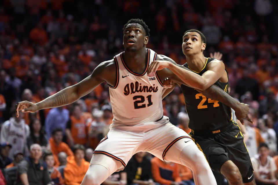 Illinois' Kofi Cockburn (21) boxes out Iowa's Kris Murray during the second half of an NCAA college basketball game Sunday, March 6, 2022, in Champaign, Ill. (AP Photo/Michael Allio)