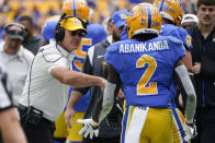 Pittsburgh head coach Pat Narduzzi greets running back Israel Abanikanda (2) after Abanikanda scored his fourth touchdown of the game during the second half of an NCAA college football game against Rhode Island, Saturday, Sept. 24, 2022, in Pittsburgh. Pittsburgh won 45-24. (AP Photo/Keith Srakocic)