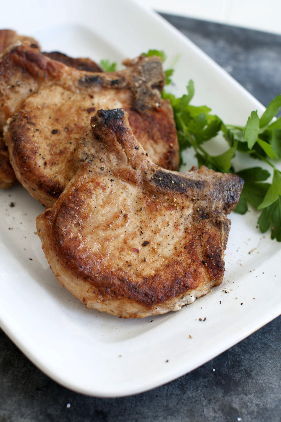 This March 17, 2014 photo shows flavored pork chops in Concord, N.H. (AP Photo/Matthew Mead)