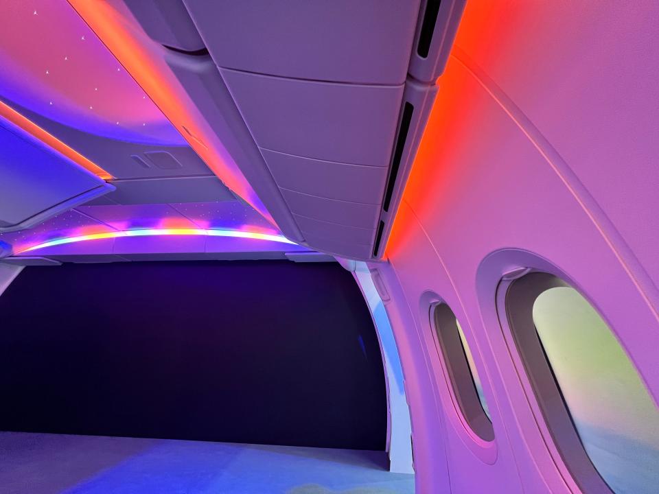 Red and pink ambient lighting in a Boeing 777X cabin mockup