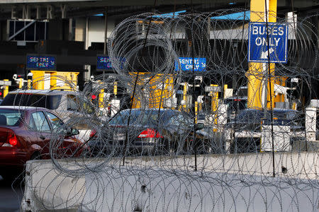 Cars are seen queue up in multiple lines through concertina wire as they wait to be inspected by U.S. border patrol officers to enter from Mexico into the U.S., at the San Ysidro point of entry, in Tijuana, Mexico April 1, 2019. REUTERS/Jorge Duenes